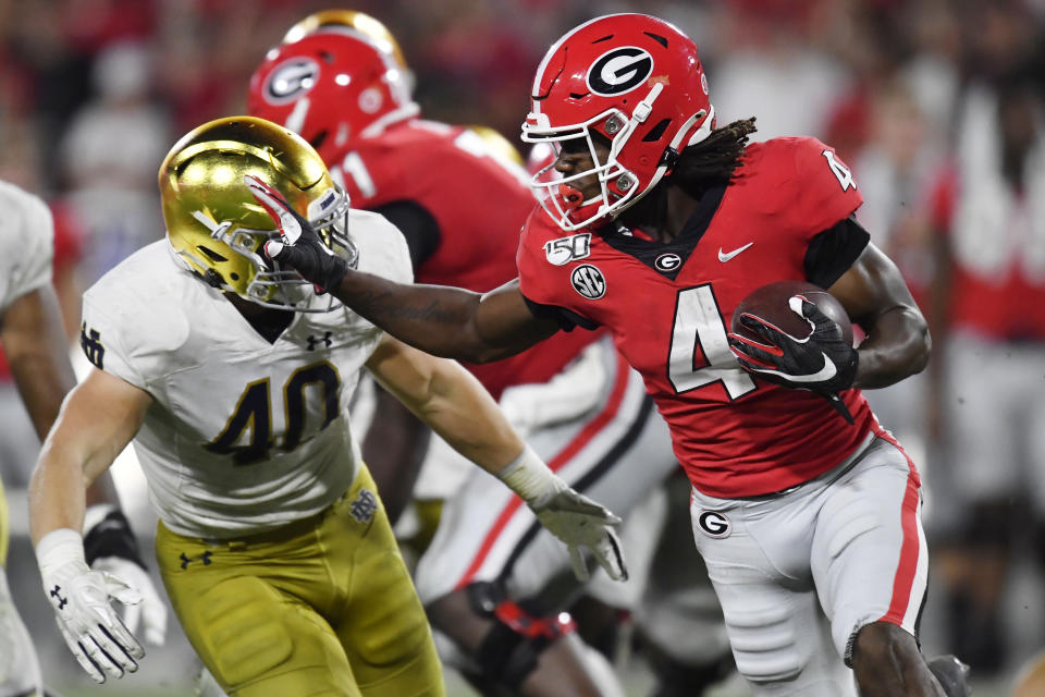 Georgia running back James Cook (4) runs against Notre Dame linebacker Drew White (40) during the second half of an NCAA college football game, Saturday, Sept. 21, 2019, in Athens, Ga. (AP Photo/Mike Stewart)