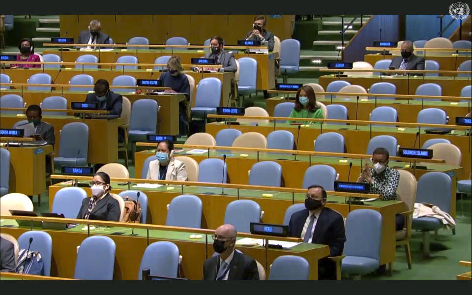 In this image made from UNTV video, representatives of different countries seated several seats apart listen to speakers during during the 75th session of the United Nations General Assembly, Tuesday, Sept. 22, 2020, at U.N. headquarters in New York. The U.N.'s first virtual meeting of world leaders started Tuesday with pre-recorded speeches from some of the planet's biggest powers, kept at home by the coronavirus pandemic that will likely be a dominant theme at their video gathering this year. (UNTV via AP)