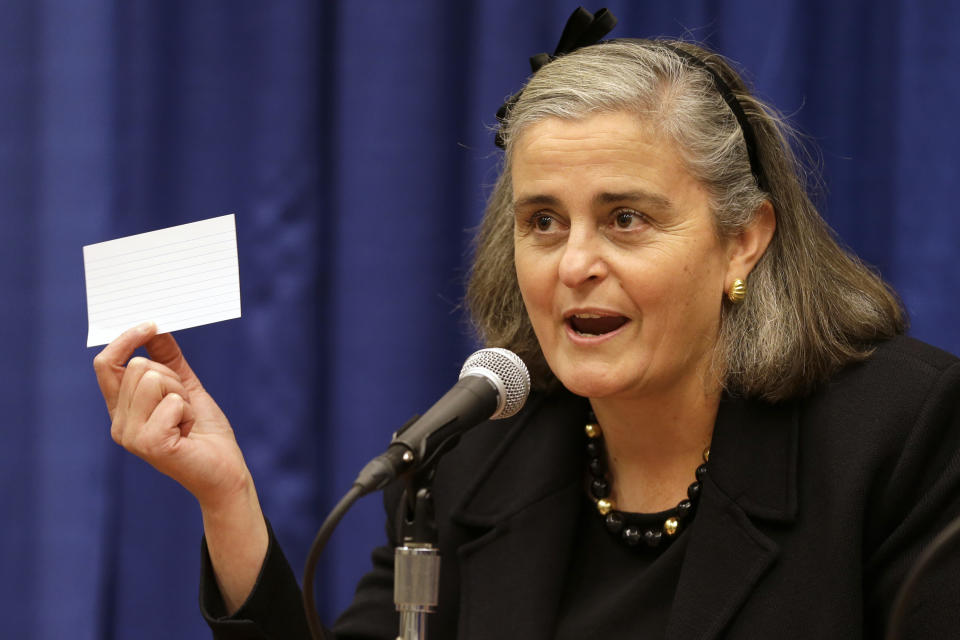 Kathryn Condon, executive director, Army National Military Cemeteries, holds up an index card demonstrating how Arlington National Cemetery used to store their records, as she presentsed the ANC Explorer application for the cemetery, Monday, Oct. 22, 2012, during a news conference in Washington. Arlington National Cemetery plans to make available to the public the detailed geospatial database it has developed over several years while overhauling its records and responding to reports of misidentified remains. The database will be available over the Internet and through a mobile phone app that visitors to the cemetery can take with them to find a specific gave anywhere in the cemetery. (AP Photo/Jacquelyn Martin)