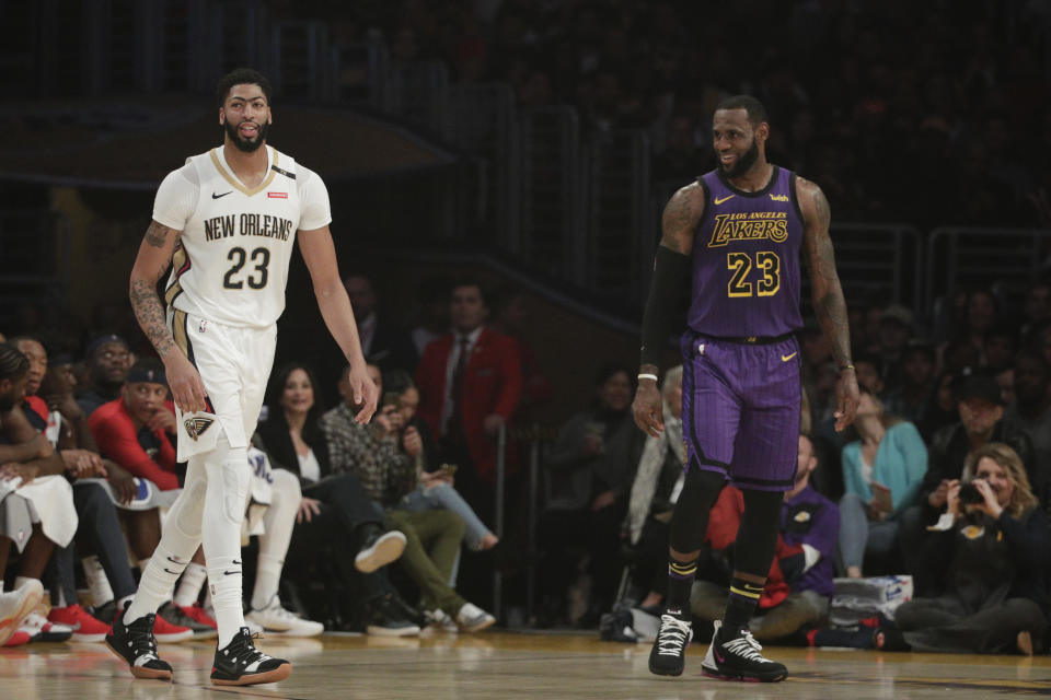 Los Angeles Lakers' LeBron James, right, New Orleans Pelicans' Anthony Davis share a light moment during the first half of an NBA basketball game, Friday, Dec. 21, 2018, in Los Angeles. (AP Photo/Jae C. Hong)