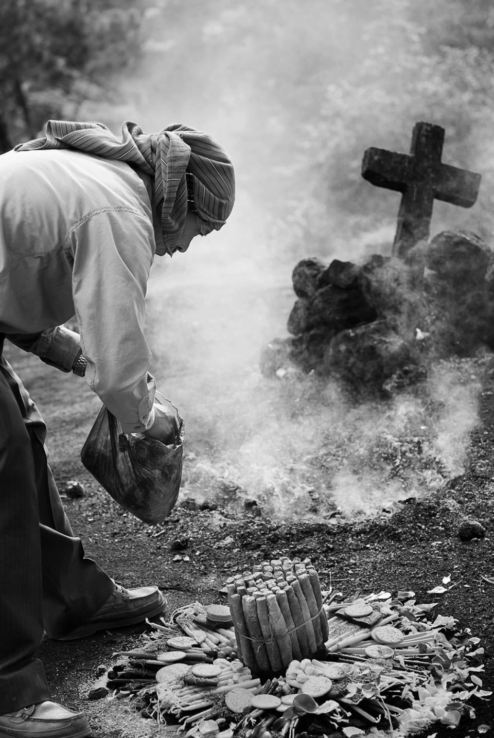 <p>A shaman prepares a ceremonial offering at Pascual Abaj, sacred Maya site in Chichicastanango, Guatemala. The Maya priest (shaman) feeds the fire with aromatic offerings. Through the fire, he communicates with the ancestors and the forces of nature, asking them to accept his offerings and grant his requests. (Photograph by Fran Antmann) </p>