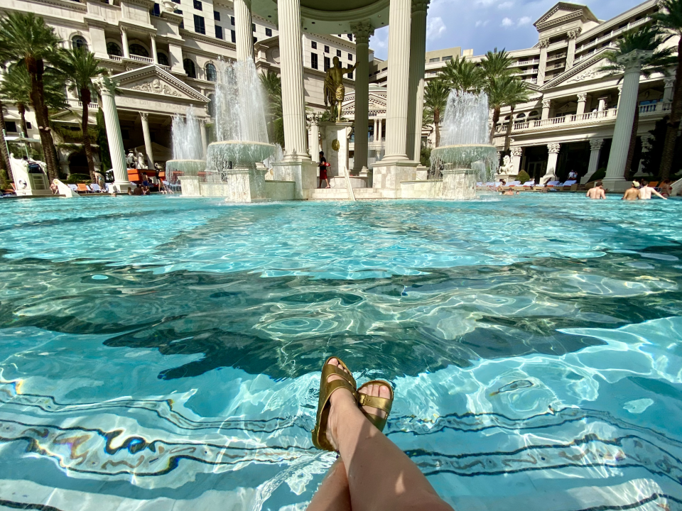 Person's legs and feet at a hotel pool