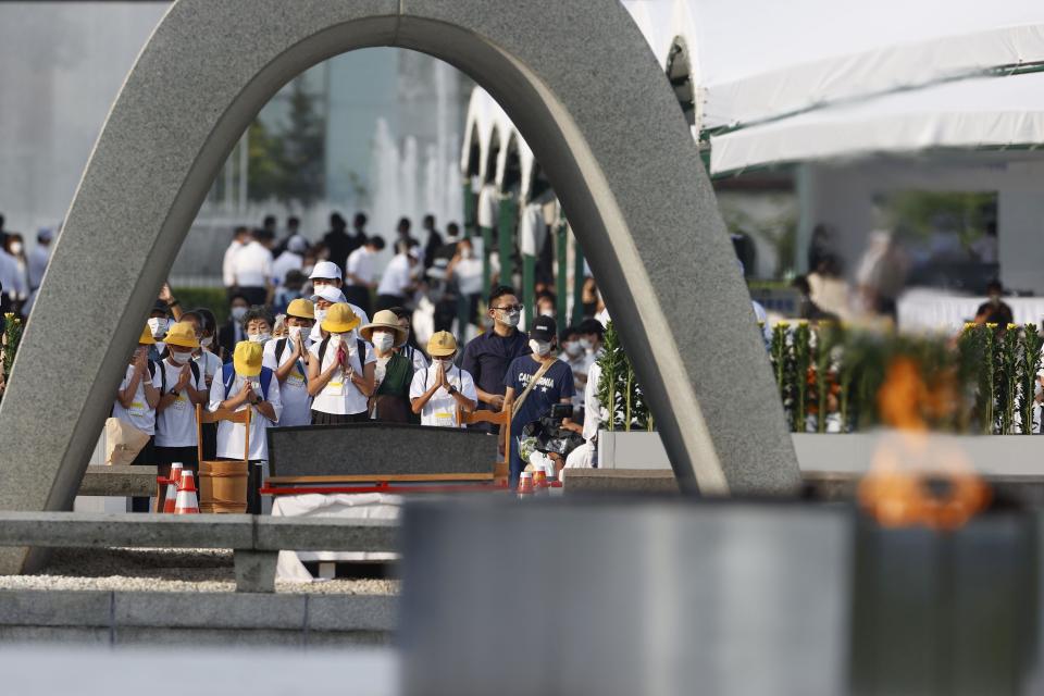 Visitors pay in front of the cenotaph dedicated to the victims of the atomic bombing at the Hiroshima Peace Memorial Park in Hiroshima, western Japan Saturday, Aug. 6, 2022. Hiroshima on Saturday marked the 77th anniversary of the world's first atomic bombing of the city. (Kenzaburo Fukuhara/Kyodo News via AP)