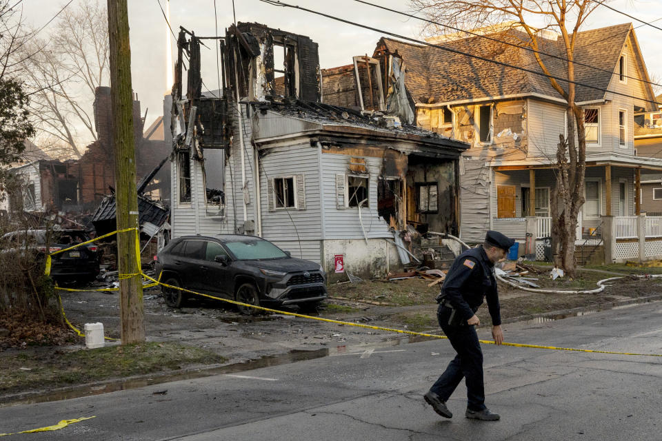 FILE - Law enforcement stand outside a home in East Lansdowne, Pa., Thursday morning, Feb. 8, 2024, where several members of a family are unaccounted for following a fire and the shooting of two police officers on Wednesday. The nation is witnessing the second-highest number on record of mass killings and deaths to this point in a single year. Only 2023 had more, with six mass killings and 39 deaths at this point last year. (Tom Gralish/The Philadelphia Inquirer via AP, File)