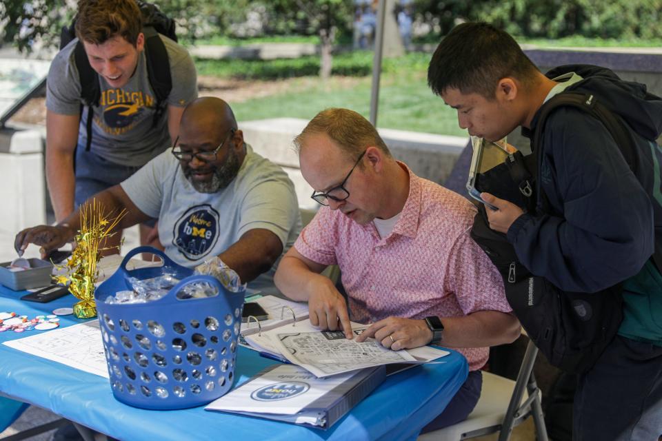 Roger Fisher, 56, of Superior Twp, left, and David Muusz, 42, of Saline, both from Student Life, help direct students to where their classes are after the wireless internet went down on the University of Michigan campus in Ann Arbor, Mich. on Tuesday, Aug. 29, 2023. "Without the internet, we became the internet," says Muusz. The Information Assurance team at the university shut down the internet at all the campuses on Sunday, Aug. 27 at 1:45 p.m. after a significant security concern was found.