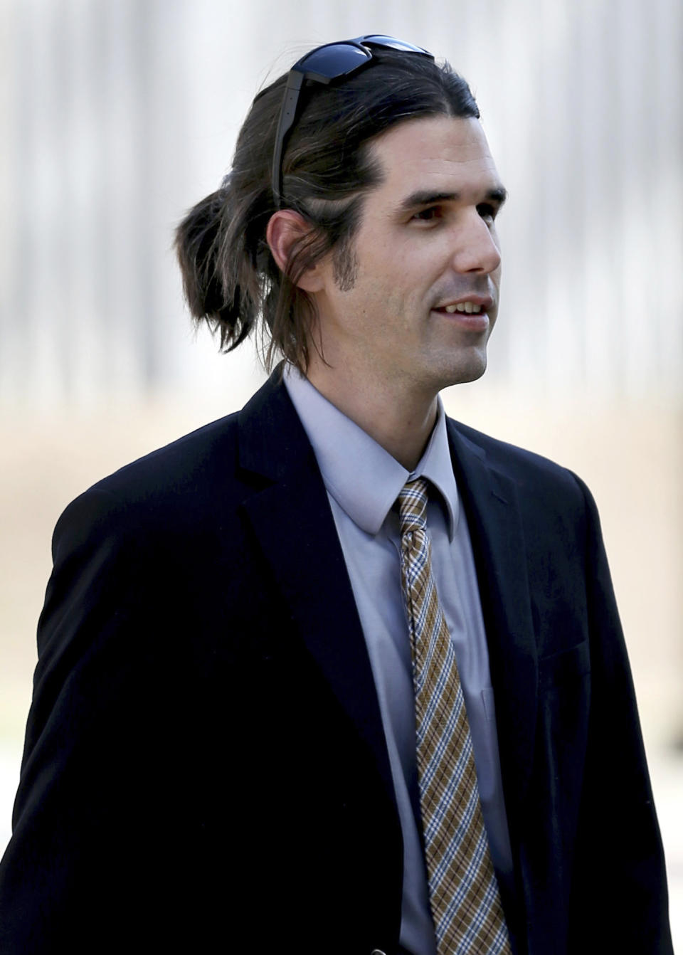 In this 2018 photo, Scott Daniel Warren, who is charged with human smuggling walks in to U.S. District Court in Tucson, Ariz. Warren, a border activist charged with helping a pair of migrants with water, food and lodging, is set to go on trial on Wednesday, May 29, 2019, in U.S. court in Arizona. (Kelly Presnell/Arizona Daily Star via AP)