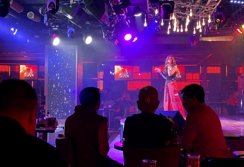 A singer performs at a nightclub in Dubai, United Arab Emirates, Nov. 5, 2020. On Thursday, Jan 21, 2021, Dubai’s tourism authorities announced an immediate halt to all live music and shows at hotels and restaurants as coronavirus cases surged to unseen heights over recent weeks. The UAE also ordered the suspension of all non-urgent surgeries to deal with an influx of new COVID-19 patients. (AP Photo/Kamran Jebreili)