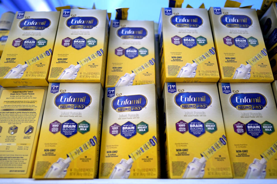 FILE - Infant formula is stacked on a table during a baby formula drive to help with the shortage May 14, 2022, in Houston. President Joe Biden has invoked the Defense Production Act to speed production of infant formula and has authorized flights to import supply from overseas. (AP Photo/David J. Phillip, File)