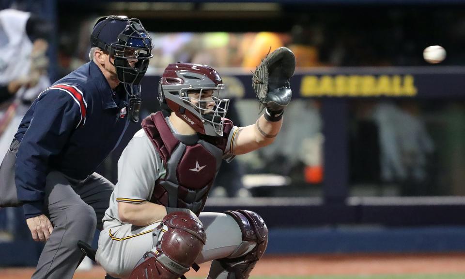 Walsh Jesuit catcher Mason Eckelman eyes down a pitch thrown by Ryan Piech during the third inning of a high school baseball game against STVM at Kent State University's Schoonover Stadium, Thursday, April 6, 2023, in Kent, Ohio.