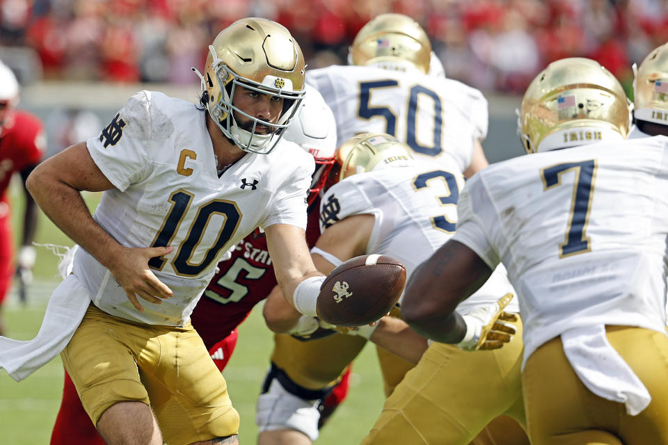 Notre Dame's Sam Hartman (10) hands the ball off to Audric Estime (7) during the second half of an NCAA college football game against North Carolina State in Raleigh, N.C., Saturday, Sept. 9, 2023. (AP Photo/Karl B DeBlaker)