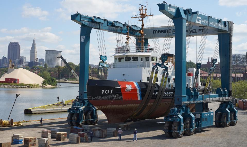 A mobile boat hoist manufactured by Marine Travelift in Sturgeon Bay transports a U.S. Coast Guard vessel at a shipyard in Cleveland, Ohio. Marine Travelift recently won a $5.2 million contract from the Coast Guard to build a new 620-ton mobile boat hoist similar to the one seen here.