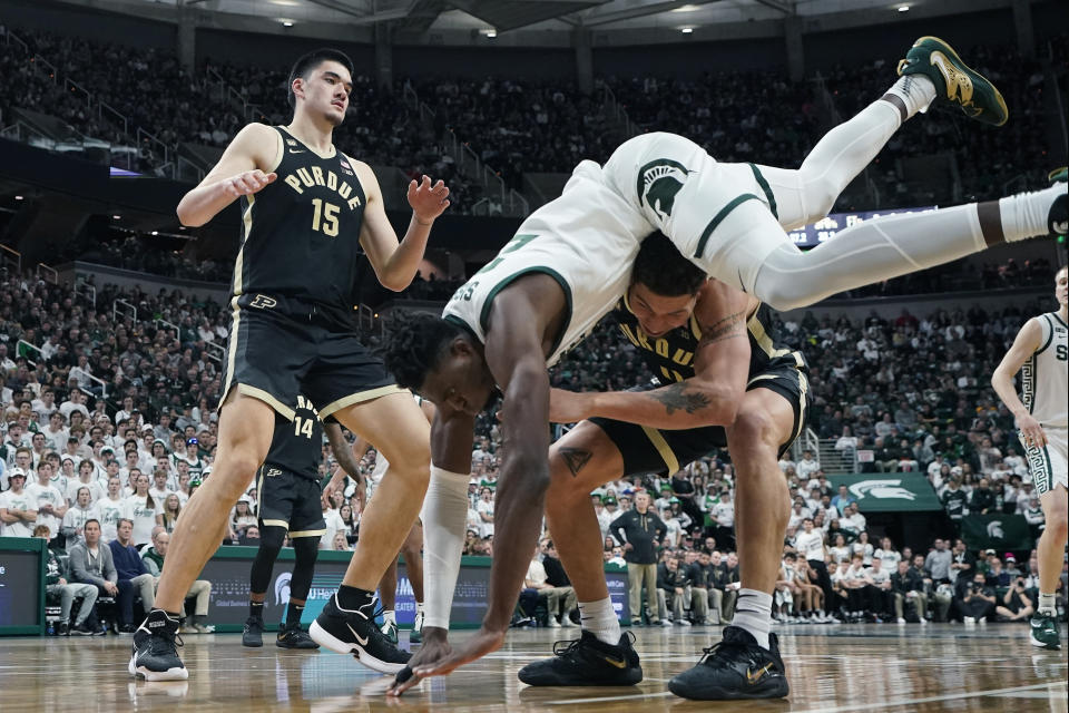 Michigan State center Mady Sissoko (22) falls over Purdue forward Mason Gillis (0) during the second half of an NCAA college basketball game, Monday, Jan. 16, 2023, in East Lansing, Mich. (AP Photo/Carlos Osorio)