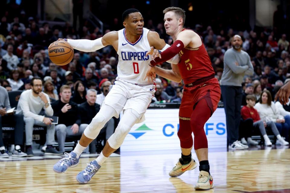 Los Angeles Clippers guard Russell Westbrook (0) drives against Cleveland Cavaliers guard Sam Merrill (5) during the first half of an NBA basketball game, Monday, Jan. 29, 2024, in Cleveland. (AP Photo/Ron Schwane)