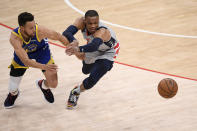 Golden State Warriors guard Stephen Curry (30) and Washington Wizards guard Russell Westbrook, right, chase a loose during the first half of an NBA basketball game, Wednesday, April 21, 2021, in Washington. (AP Photo/Nick Wass)