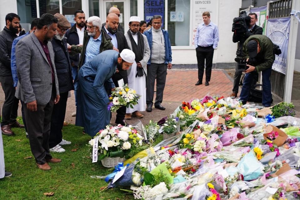 Religious leaders from Southend mosques lay flowers near Belfairs Methodist Church (PA)