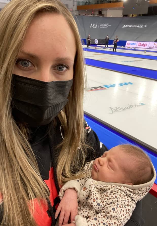 Rachel Homan holds daughter Bowyn inside Calgary's WinSport Arena during the women's Grand Slam of Curling.