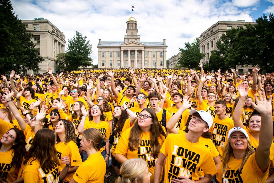 Students from the University of Iowa Class of 2026 wave to a drone while posing for a group photo, Sunday, Aug. 21, 2022, on the Pentacrest in Iowa City, Iowa. The annual "Kickoff at Kinnick" event, where the class photo traditionally takes place, was canceled on Friday due to heavy rain and thunderstorms.