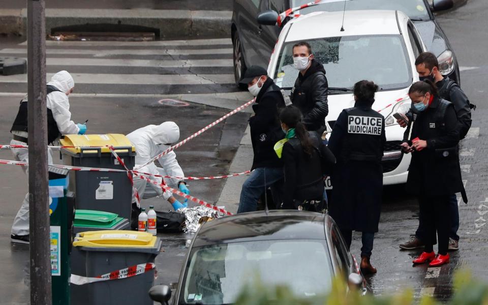 Police at the site of the September 2020 attack near the former offices of the satirical paper, Charlie Hebdo - AP