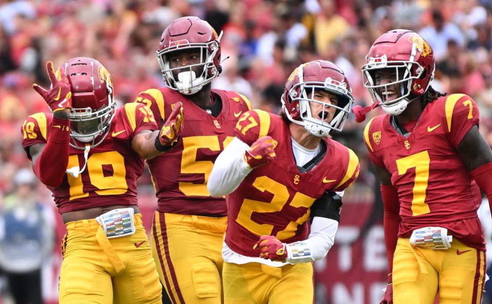 USC defenders celebrate after a key tackle against Nevada