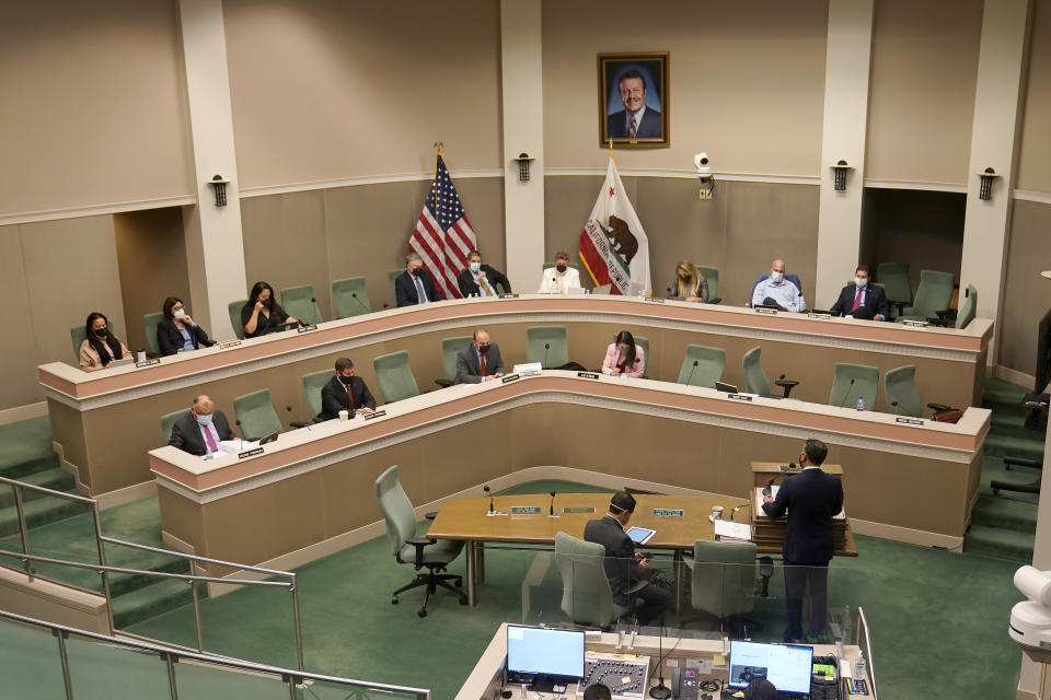 Assemblyman Ash Kalra, D-San Jose, bottom right, presents his measure to create a universal healthcare system, during a hearing of the Assembly Health Committee in Sacramento, Calif., Tuesday, Jan. 11, 2022. (AP Photo/Rich Pedroncelli)