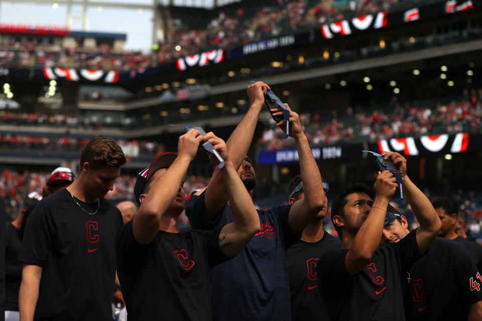 The Cleveland Guardians look up at the total solar eclipse before the home opener against the Chicago White Sox at Progressive Field on April 08, 2024 in Cleveland, Ohio.