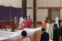 In this photo provided by the Imperial Household Agency of Japan, Japan's Crown Prince Akishino, in orange robe, flanked by his wife Crown Princess Kiko, attends a ceremony for formally proclaims Akishino is the first in line to the Chrysanthemum Throne, in front of Emperor Naruhito, left, and Empress Masako, second from left, at the Imperial Palace in Tokyo, Sunday, Nov. 8, 2020. Akishisho, Naruhito's younger brother, was formally sworn in as first in line to the Chrysanthemum Throne in a traditional palace ritual that has been postponed for seven month and scaled down due to the coronavirus pandemic. (Imperial Household Agency of Japan via AP)