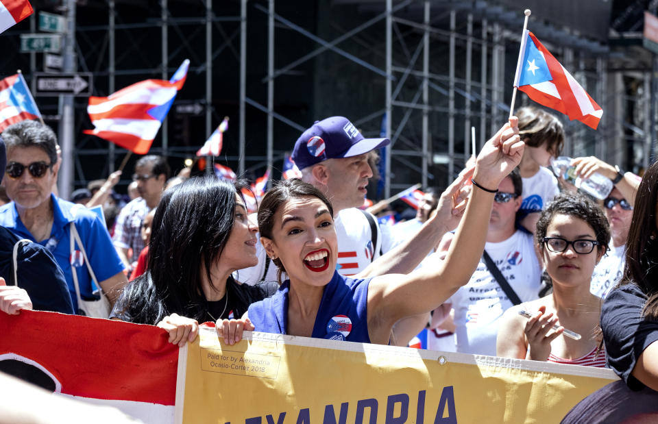 Rep. Alexandria Ocasio-Cortez, D-N.Y., center, takes part in the National Puerto Rican Day Parade Sunday, June 9, 2019, in New York. (AP Photo/Craig Ruttle)