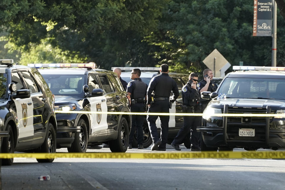 Sacramento Police officers gather near the scene of shooting outside a night club in the early morning hours on Monday July 4, 2022 in downtown Sacramento, Calif. (AP PhotoRich Pedroncelli)