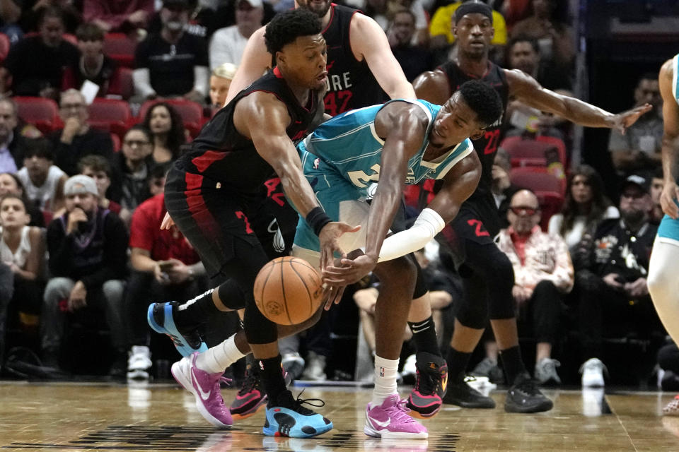 Charlotte Hornets forward Brandon Miller, right, passes the ball as Miami Heat guard Kyle Lowry, left, defends during the first half of an NBA basketball game, Wednesday, Dec. 13, 2023, in Miami. (AP Photo/Lynne Sladky)