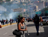 <p>A girl plays the instrument during clashes with security forces at a rally against Venezuelan President Nicolas Maduro’s government in Caracas, Venezuela, July 6, 2017. (Photo: Andres Martinez Casares/Reuters) </p>