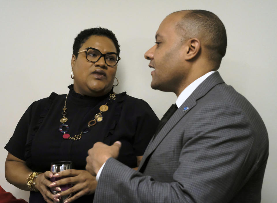 Del. Marcia Price, D-Newport News, left, and Garrett Arwa, Director of Capaigns for the National Democratic Redistricting Committee, right, confer before a press conference dealing with Price's HB1256, a redestricting bill, inside the Pocahontas Building in Richmond, Va., Tuesday, Jan. 14, 2020. (Bob Brown/Richmond Times-Dispatch via AP)