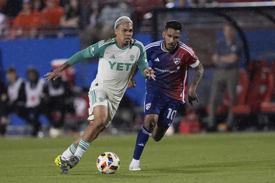 Austin FC midfielder Daniel Pereira, left, moves the ball against FC Dallas forward Jesus Ferreira (10) during the second half of an MLS soccer match Saturday, May 11, 2024, in Frisco, Texas. (AP Photo/LM Otero)