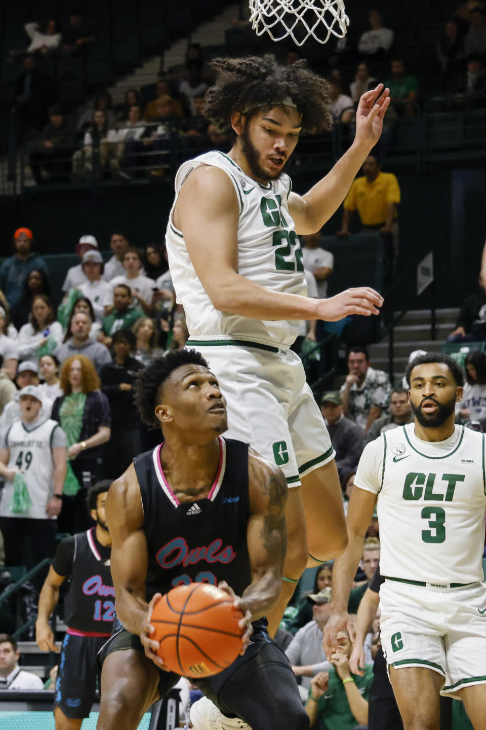 Florida Atlantic guard Brandon Weatherspoon, bottom left, looks to shoot against Charlotte forward Josh Aldrich (22) as Charlotte guard Brice Williams (3) looks on during the first half of an NCAA college basketball game in Charlotte, N.C., Saturday, Feb. 4, 2023. (AP Photo/Nell Redmond)