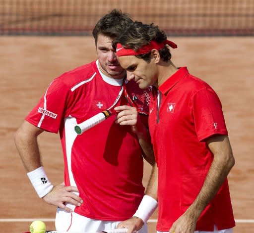 Switzerland's Roger Federer (R) and Stanislas Wawrinka speak during the Davis Cup World Group play-off doubles match against Netherlands' Jean-Julien Rojer and Robin Haase in Amsterdam. Netherlands won the match