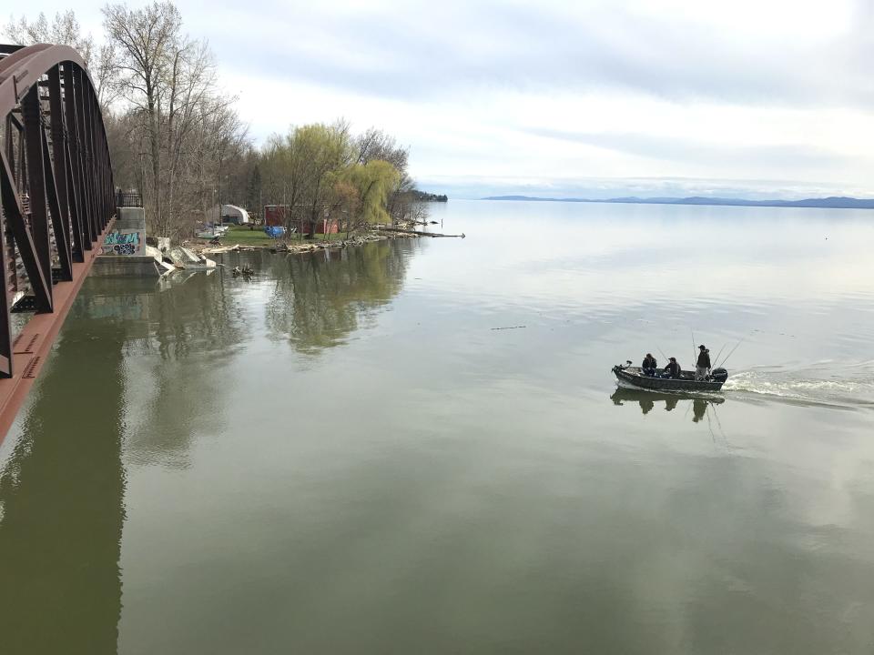 A fishing boat on Lake Champlain is about to pass under the bridge on the recreation path and enter the Winooski River on Sunday, May 5, 2019.