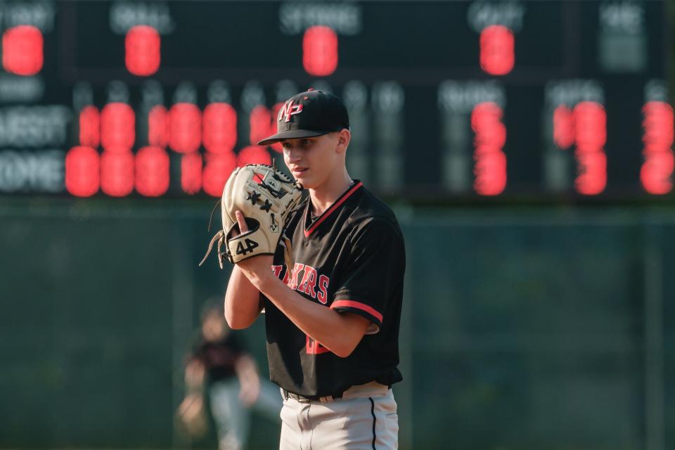 New Philadelphia starting pitcher Owen Courtney looks into home plate for a signal during a Division II district final, Wednesday, May 24, at Coshocton Lake Park.