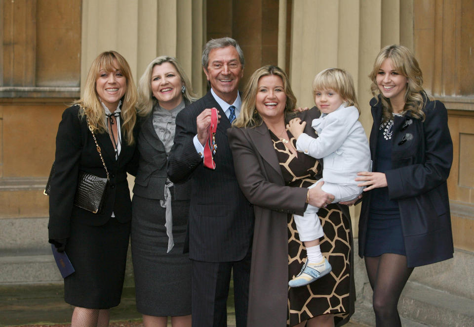 File photo dated 02/12/08 of veteran entertainer Des O'Connor with his (left to right) daughters Samantha and Karen, wife Jodie, son Adam, 4, and daughter Kristina, receiving his CBE at Buckingham Palace, London. Des O'Connor sadly passed away on Saturday 14 November aged 88. His agent confirmed he had been admitted to hospital just over a week ago, following a fall at his home in Buckinghamshire. Unfortunately yesterday evening his condition suddenly deteriorated and he drifted peacefully away in his sleep.