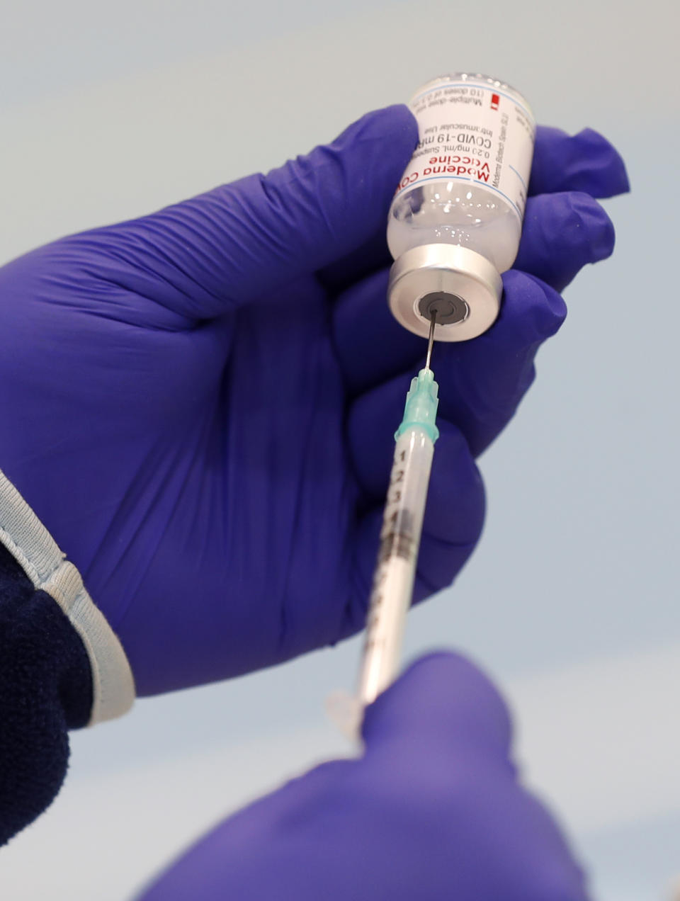 A healthcare worker prepares a Moderna COVID-19 vaccine at a sports hall in Ricany, Czech Republic, Friday, Feb. 26, 2021. With new infections soaring due to a highly contagious coronavirus variant and hospitals filling up, one of the hardest-hit countries in the European Union is facing inevitable: a tighter lockdown. (AP Photo/Petr David Josek)