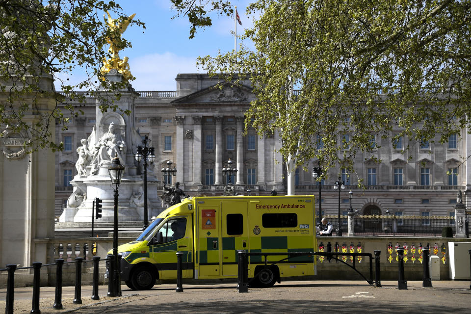 An ambulance is seen outside Buckingham Palace, during to the Coronavirus outbreak, in London, Tuesday, April 14, 2020. The new coronavirus causes mild or moderate symptoms for most people, but for some, especially older adults and people with existing health problems, it can cause more severe illness or death.(AP Photo/Alberto Pezzali)