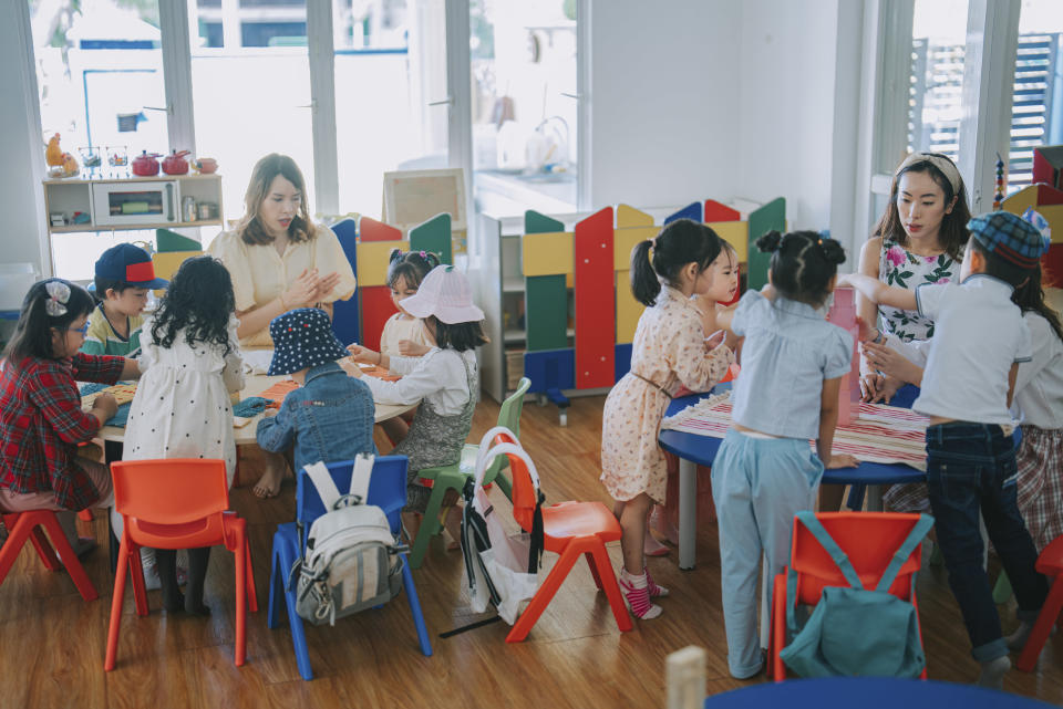 Children and teachers working in a classroom