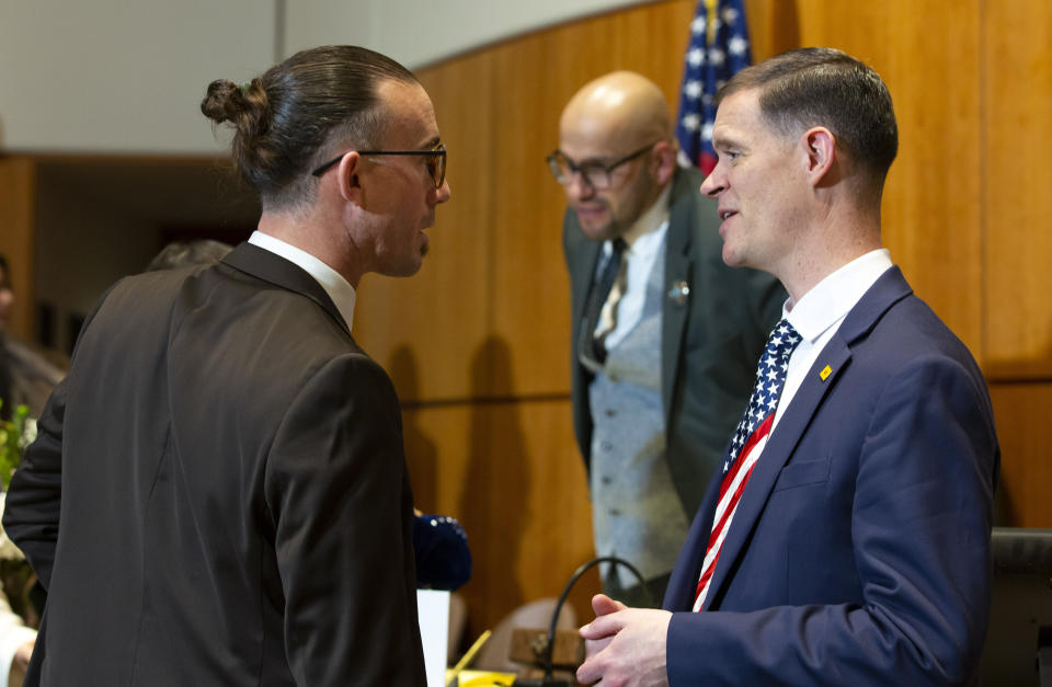 Republican New Mexico State Representatives Jason Harper, right, of Rio Rancho, and Ryan Lane, of Aztec, talk during the opening day of an annual legislative session in the House of Representatives in Santa Fe, N.M., on Tuesday, Jan. 17, 2023. The Democratic-led Legislature prepared to tap a multibillion-dollar budget surplus as they take on daunting challenges of crime, lagging student achievement in schools and below-average workforce participation. (AP Photo/Andres Leighton)