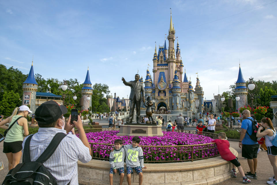 FILE - People visit the Magic Kingdom Park at Walt Disney World Resort in Lake Buena Vista, Florida, on April 18, 2022. Florida lawmakers will meet Monday, Feb. 6, 2023, to complete a state takeover Walt Disney World's self-governing district and debate proposals on immigration and election crimes, as Republican Gov. Ron DeSantis continues to leverage national political fissures ahead of an expected White House run. (AP Photo/Ted Shaffrey, File)