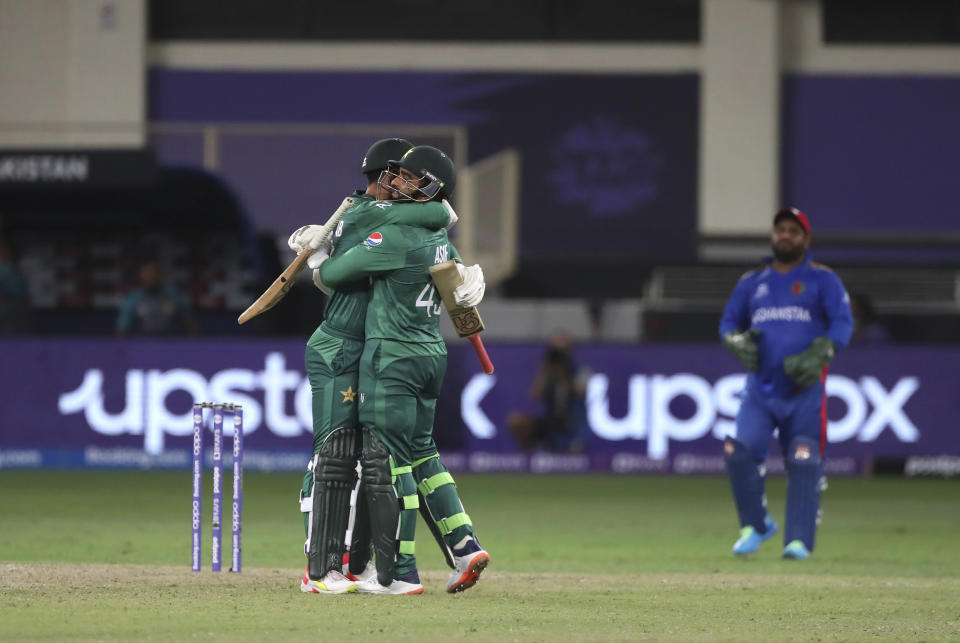 Pakistan's Asif Ali, center, hugs teammate Shadab Khan to celebrate their win during the Cricket Twenty20 World Cup match between Pakistan and Afghanistan in Dubai, UAE, Friday, Oct. 29, 2021. (AP Photo/Aijaz Rahi)