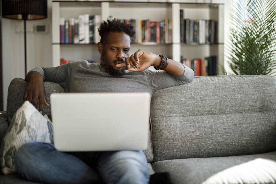 person using their laptop on the couch