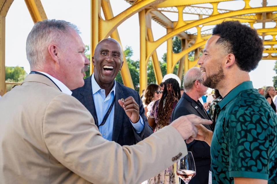 Sacramento County Sheriff Jim Cooper, center, laughs with Sacramento State President Jonathan Luke Wood, right, and undersheriff Mike Ziegler, left, at the Tower Bridge Dinner on the Tower Bridge between Sacramento and West Sacramento on Sunday.