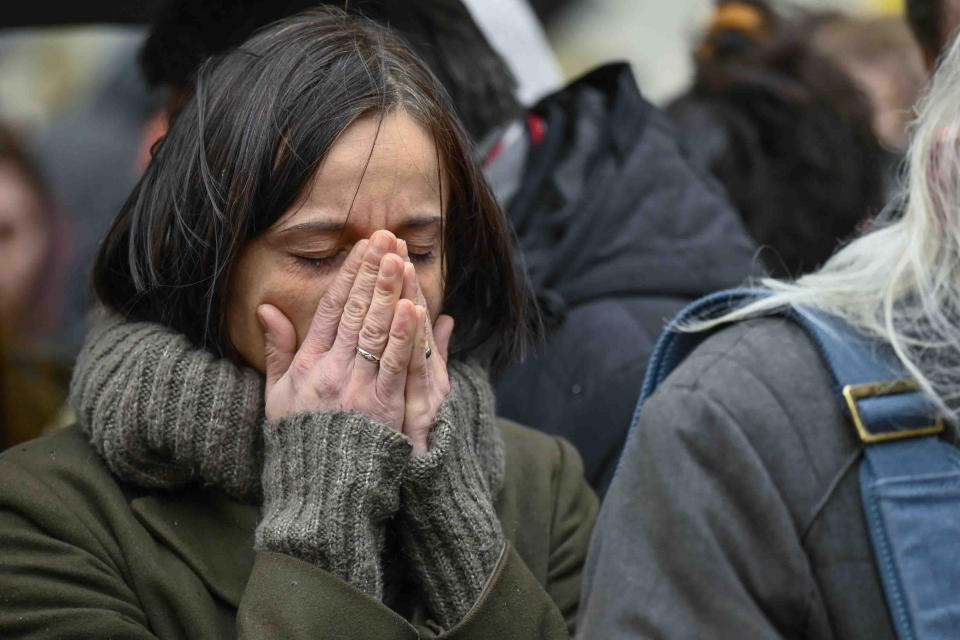 A woman cries outside the headquarters of Charles University for victims of mass shooting in Prague, Czech Republic, Friday, Dec. 22, 2023. A lone gunman opened fire at a university on Thursday, killing more than a dozen people and injuring scores of people. (AP Photo/Denes Erdos)