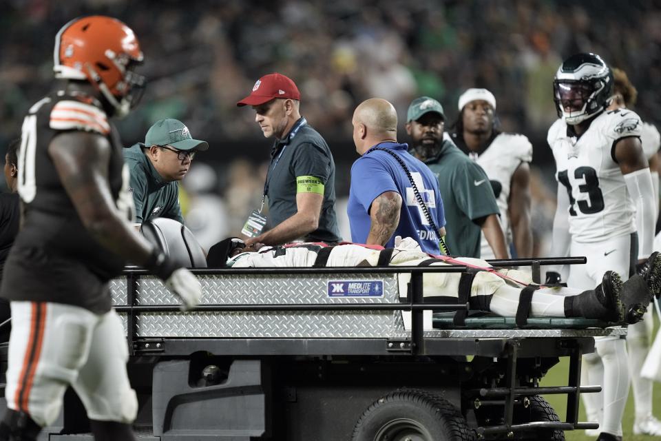 Philadelphia Eagles defensive tackle Moro Ojomo (72) is brought off the field after an injury during the second half of an NFL preseason football game against the Cleveland Browns on Thursday, Aug. 17, 2023, in Philadelphia. (AP Photo/Matt Rourke)