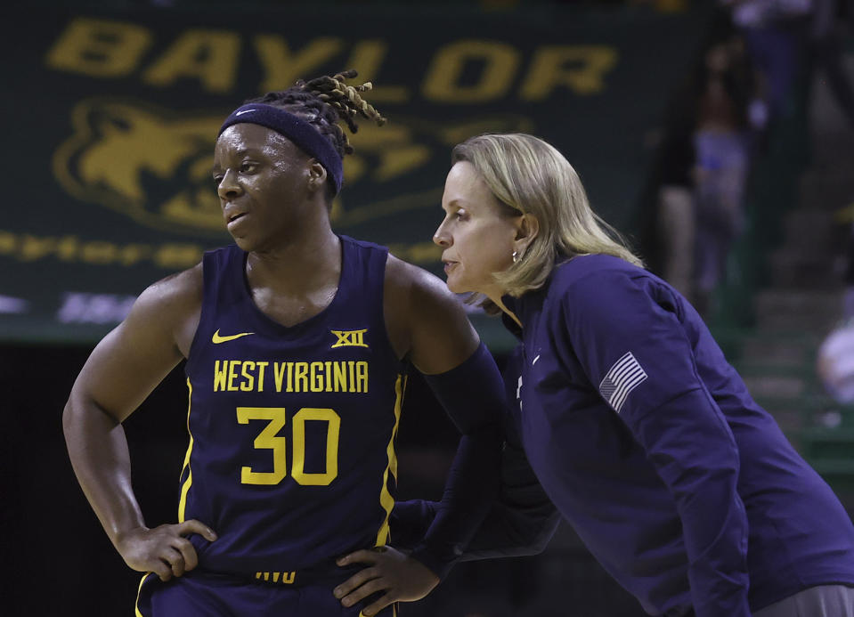 West Virginia coach Dawn Plizuweit speaks to guard Madisen Smith during the first half of the team's NCAA college basketball game against Baylor on Saturday, March 4, 2023, in Waco, Texas. (Jerry Larson/Waco Tribune-Herald via AP)