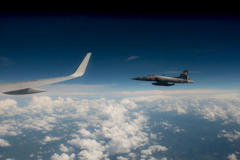 A Mexican Air Force F-5 jet escorts the presidential plane in Mexico City September 23, 2012.