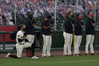 San Francisco Giants' Hunter Pence, left, kneels during the national anthem before a baseball game between the Giants and the Los Angeles Angels in San Francisco, Thursday, Aug. 20, 2020. (AP Photo/Jeff Chiu)